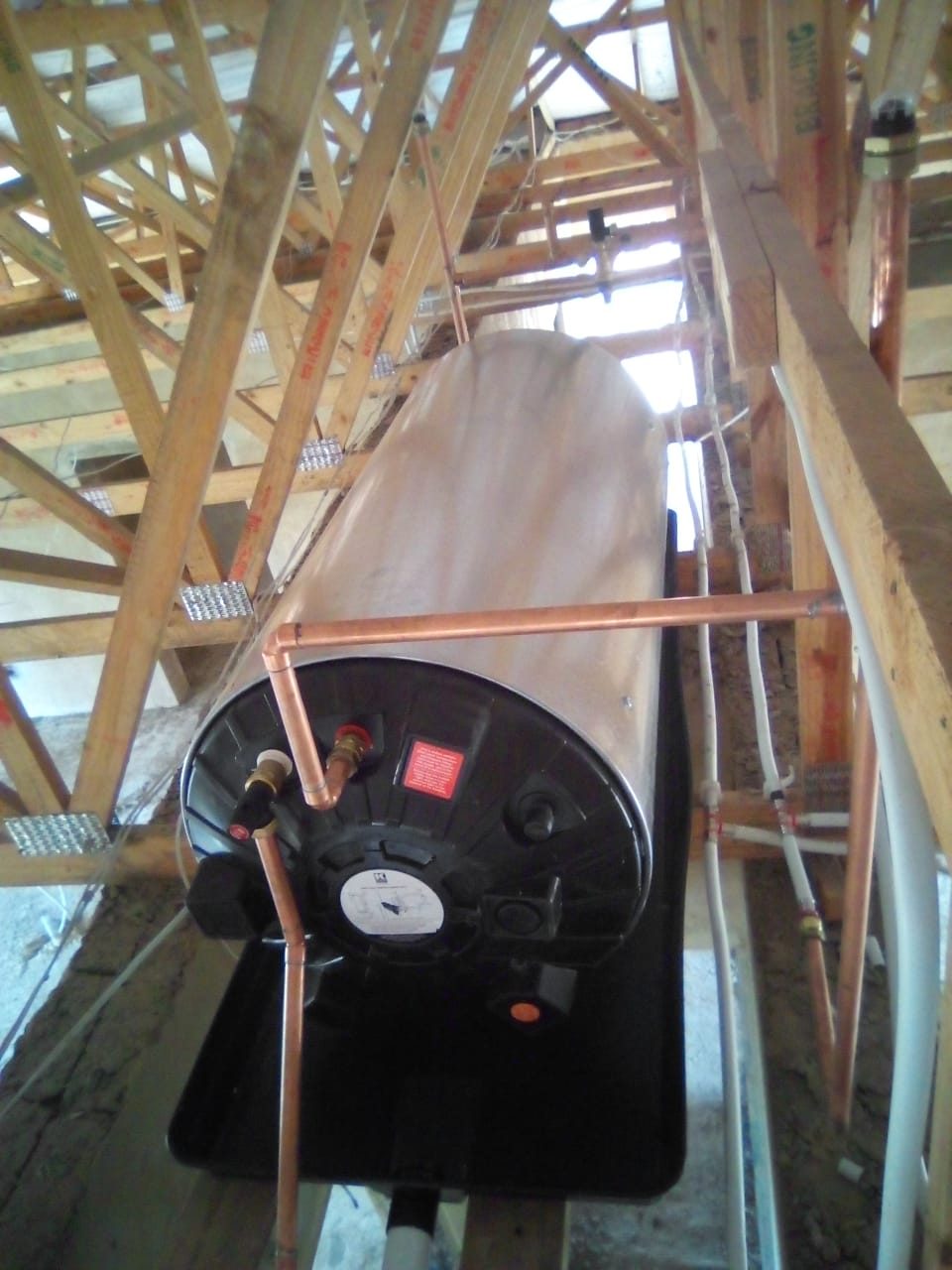 Geyser installed in a roof space with copper piping
